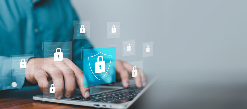 Cybersecurity protection concept with hands typing on laptop and digital shield lock interface, symbolizing data protection, network security, encryption technology, privacy defense, secure systems.