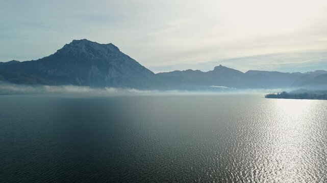 Aerial view of Traunsee lake with morning fog and Traunstein mountain, Austria