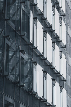 Concrete facade windows form a modern office architecture grid with repeating pattern and repetition creating abstract minimal texture background