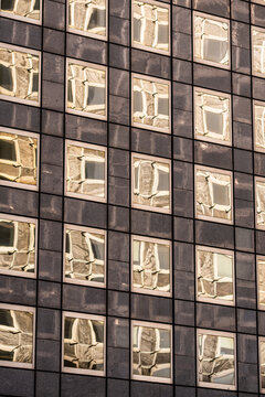 Symmetry in windows grid pattern across modern office facade shows abstract architecture texture for clean geometric background concept