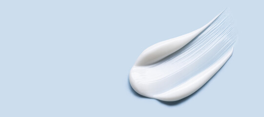 cosmetic cream smear, smooth and shiny texture, blue background
