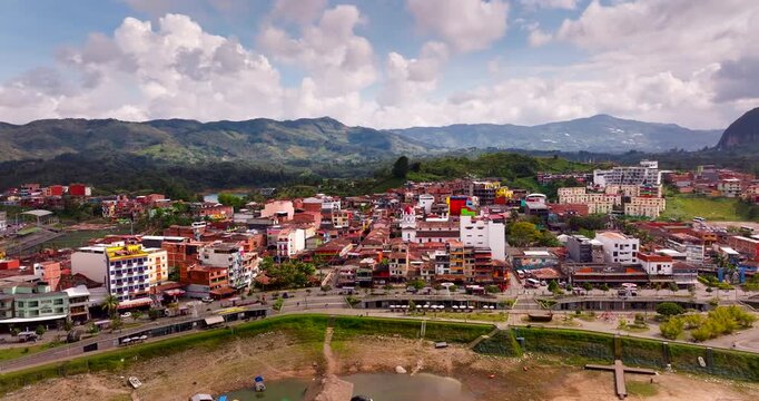 Buildings on Penol-Guatape waterfront with Piedra del Pe&ntilde;ol in back. Aerial