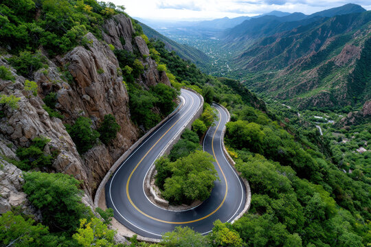 Winding mountain road with switchbacks and valley views
