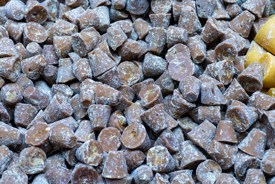 Close-up Shot of Piloncillo Traditional Unrefined Sugar Cones Pile in Market