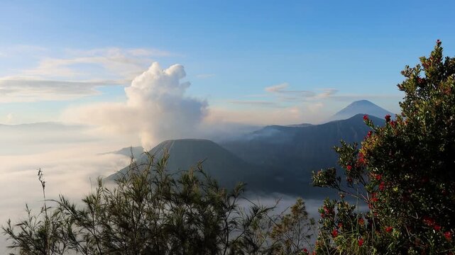 Gunung Batok Cinder Cone with Mount Bromo Eruption from King Kong Hill, East Java, Indonesia