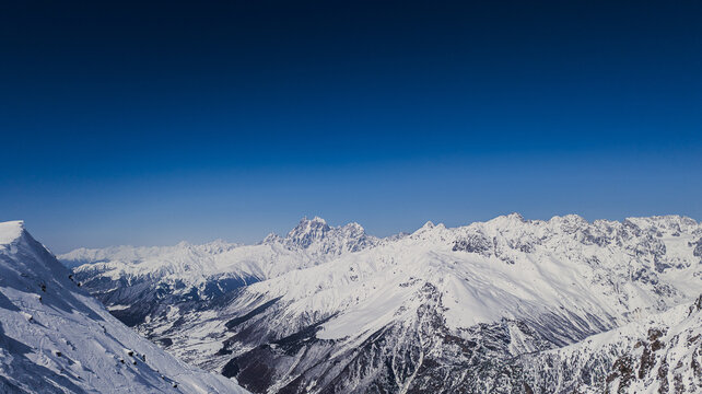 Breathtaking panoramic view of Mount Ushba and Caucasus mountain range in winter.