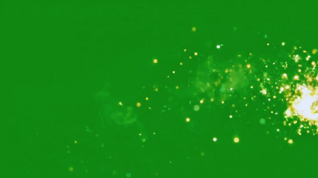 Brilliant golden light streak with sparkling particles rapidly moving across a vibrant green screen background video footage