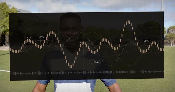 Man on sports field folding arms as overlay appearing over torso and driving waveform for analysis