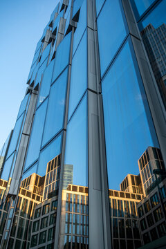 Abstract glass facade with reflections and geometric windows on a modern office skyscraper in Frankfurt Germany financial district exterior