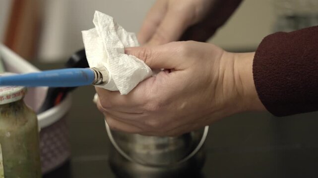 Close up of hands sealing professional turpentine Stainless Steel Brush washer