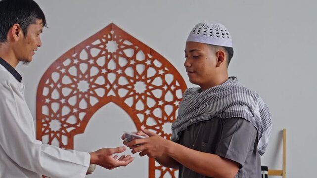 Muslim man hands bag of rice to recipient symbolizing Islamic tradition of Zakat Al-Fitr in mosque