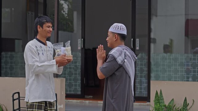 Muslim man giving Zakat Al-Fitr rice to person in need