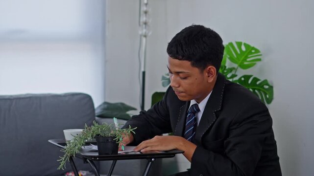 Office worker moving laptop and papers to avoid roof leak
