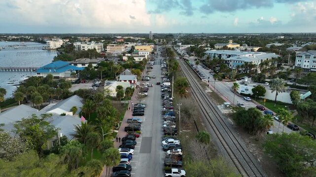 An aerial view captured flying over downtown Stuart&rsquo;s charming architecture and palm-lined streets beside the St. Lucie River.
