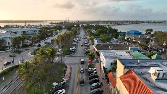 A warm sunset aerial captures the relaxed coastal atmosphere of Stuart, Florida overlooking the expansive riverfront.