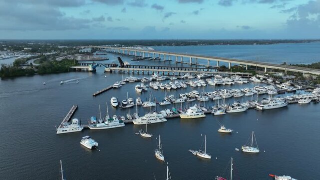 A sweeping aerial shot reveals the peaceful marina landscape of Stuart&rsquo;s Sunset Bay Marina glowing under warm golden hour light.