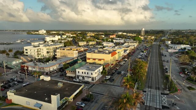 A golden-hour drone perspective showcases the coastal town of Stuart with the St. Lucie River stretching across the horizon.