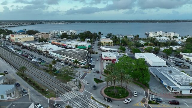 A cinematic golden-hour aerial showcases Stuart&rsquo;s downtown streets and roundabout framed by the calm waters of the Treasure Coast.