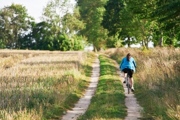 Obraz premium Rear view of a woman riding a bike