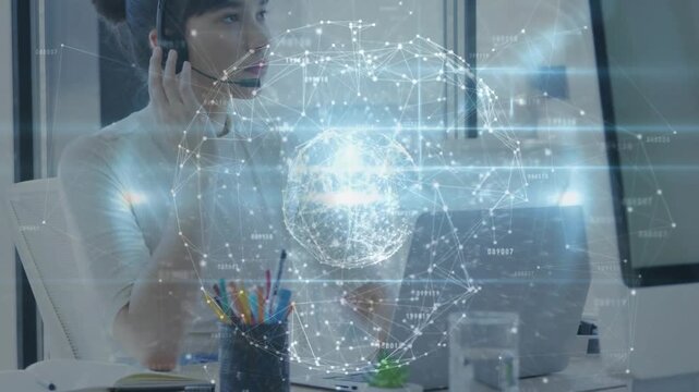 Woman adjusting headset typing while holo globe appearing over laptop rotating doing tech support