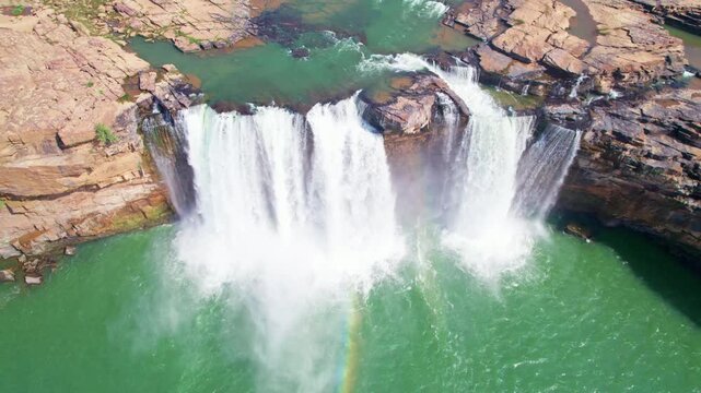Top-down drone view of Chitrakote Waterfall with cascading falls and rainbow.