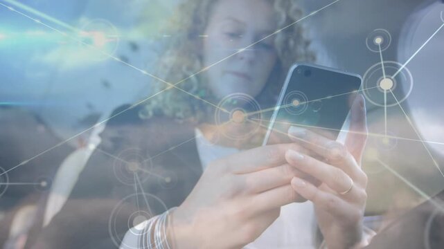 Woman bringing phone into view in aircraft, tapping screen and syncing travel data with cloud nodes