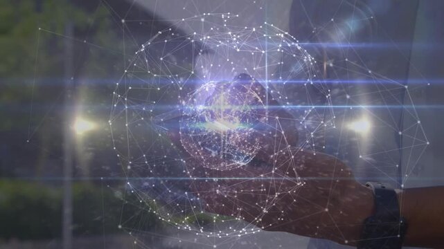Adult man cupping hand by glass, aligning and revealing rotating globe above palm showing tech data