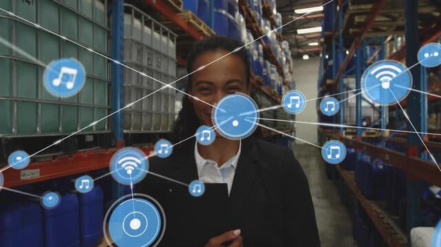 Woman holding clipboard blue icon appearing by face and linking into logistics network in warehouse