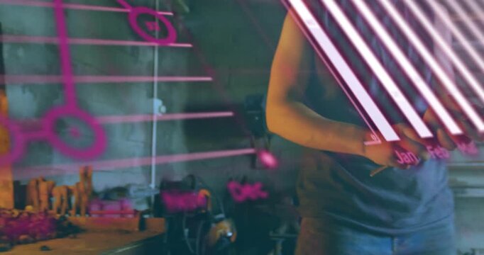 Male smith removing hot metal with tongs from furnace and forging at bench, pink overlays sweeping