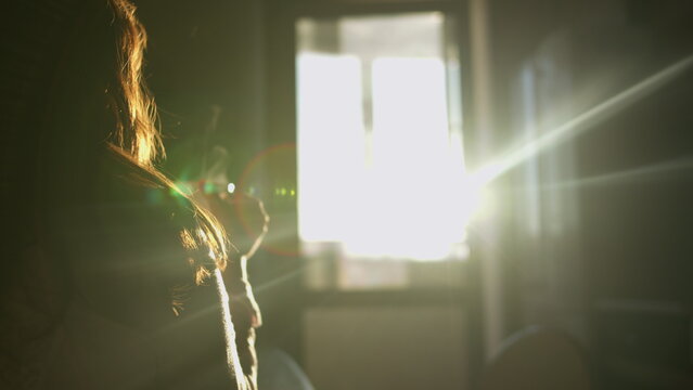 Woman Relaxing Near Bright Window with Sunlight, have fun and enjoy