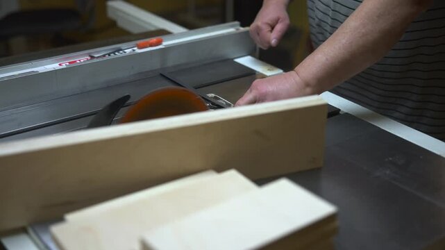 Highly Trained Woodworker Carefully Slices Layered Pine Planks To Precise Measurements In Workshop. Media