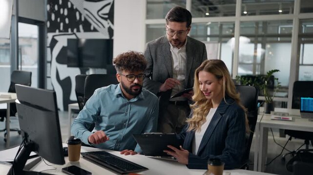 Multiethnic three business colleagues team at briefing meeting discussing papers holding folder in office Caucasian man with digital tablet with European woman Arabian male multinational cooperation