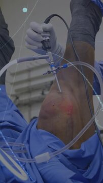 Vertical video: Surgeon inserting scope into knee, guiding tubing with HUD assessing joint