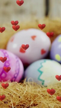 Vertical video: Camera pulling back revealing decor eggs in nest, hearts floating over eggs for ad
