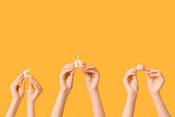 Female hands with human internal organ models on yellow background