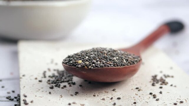 Chia seeds on a wooden spoon ready for use in recipes