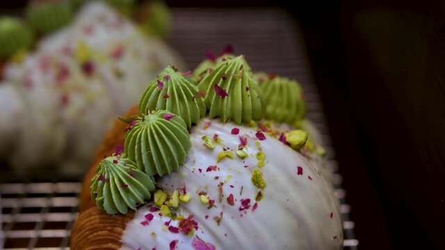 croissant with sweet filling Freshly baked italian croissants and cannoli with various fillings like cream, pistachio resting on trays inside a refrigerated glass display case at a local pastry shop