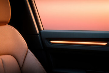Obraz premium Car interior leather seat orange light sunset window modern design luxury close up ambient lighting minimal style