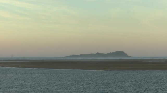 Scenic view of Urdaibai wetland in Bizkaia, a biosphere reserve and key migratory bird habitat. Natural marsh landscape with tidal waters, vegetation, and peaceful environmental biodiversity.