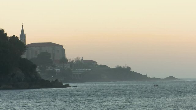 Scenic view of Mundaka on the Cantabrian coast in Bizkaia, famous worldwide for its powerful left-hand surf wave. Coastal town landscape with ocean swell, harbor, and natural surroundings.