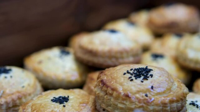black sesame Golden brown pain au chocolat filled with dark chocolate displayed on a tray bakery, tempting passersby with their delicious aroma