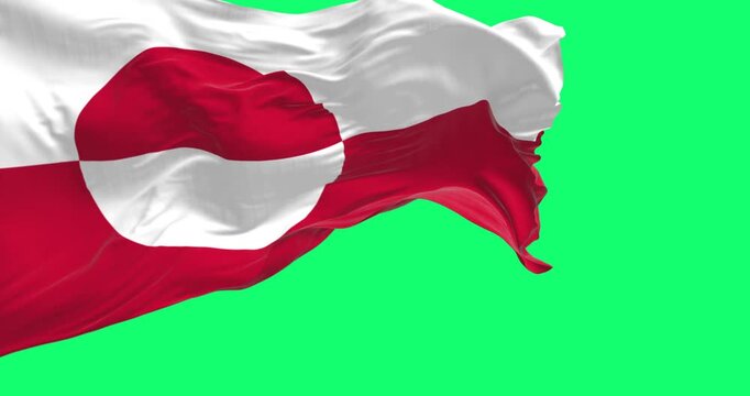 The flag of Greenland waving in the wind isolated on green background