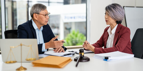 Lawyer team diligently reviewing legal documents at desk.Law and Legal services concept.