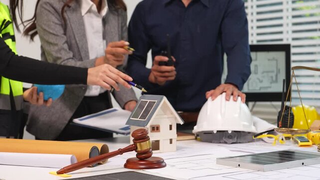 Construction Law and Sustainable Building Planning with Solar House Model and Legal Scale.