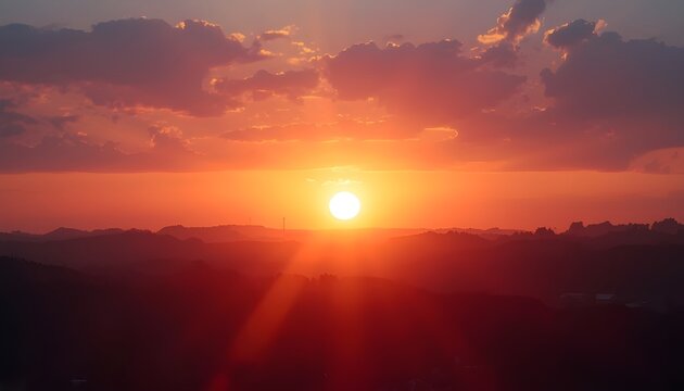 A serene landscape of a vibrant sunset over a mountain range with a peaceful sky