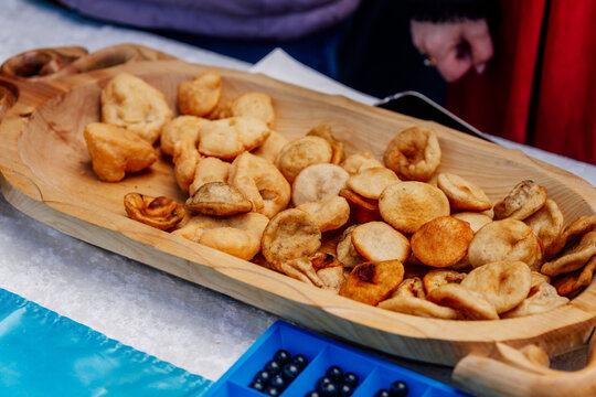 Kazakh baursaks in wooden national dishes. fried dough for the holiday Nauryz