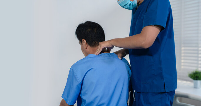Patient at the physiotherapy doing physical exercises with therapist.
