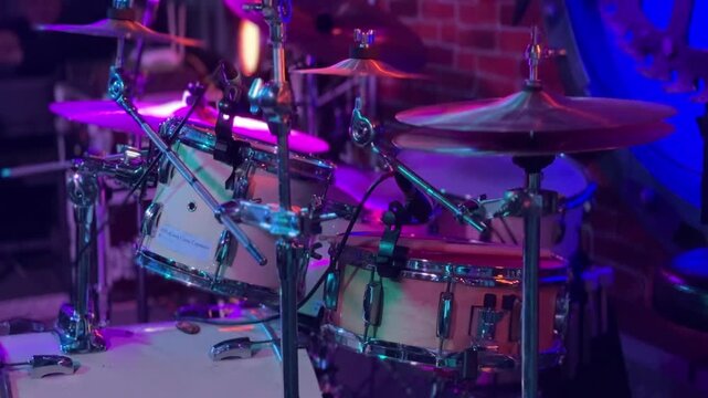 This video showcases a vibrant drum set with colorful lighting effects, perfect for capturing the energy of live music performances. Ideal for music-related projects.