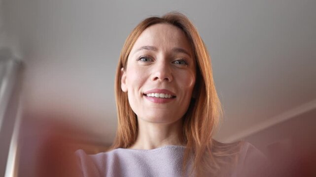 Curious woman looking down into cardboard box