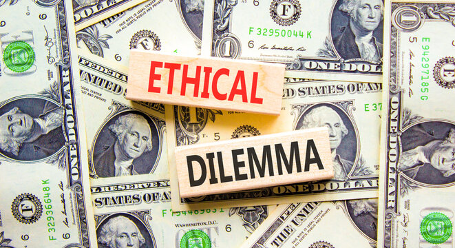 Ethical dilemma words symbol. Concept words Ethical dilemma on beautiful wooden blocks. Beautiful dollar bills background. Dollar bills. Business and Ethical dilemma words concept. Copy space.